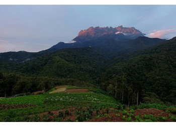 Sunlight Creeping Over The Jagged Peaks of Mt Kinabalu